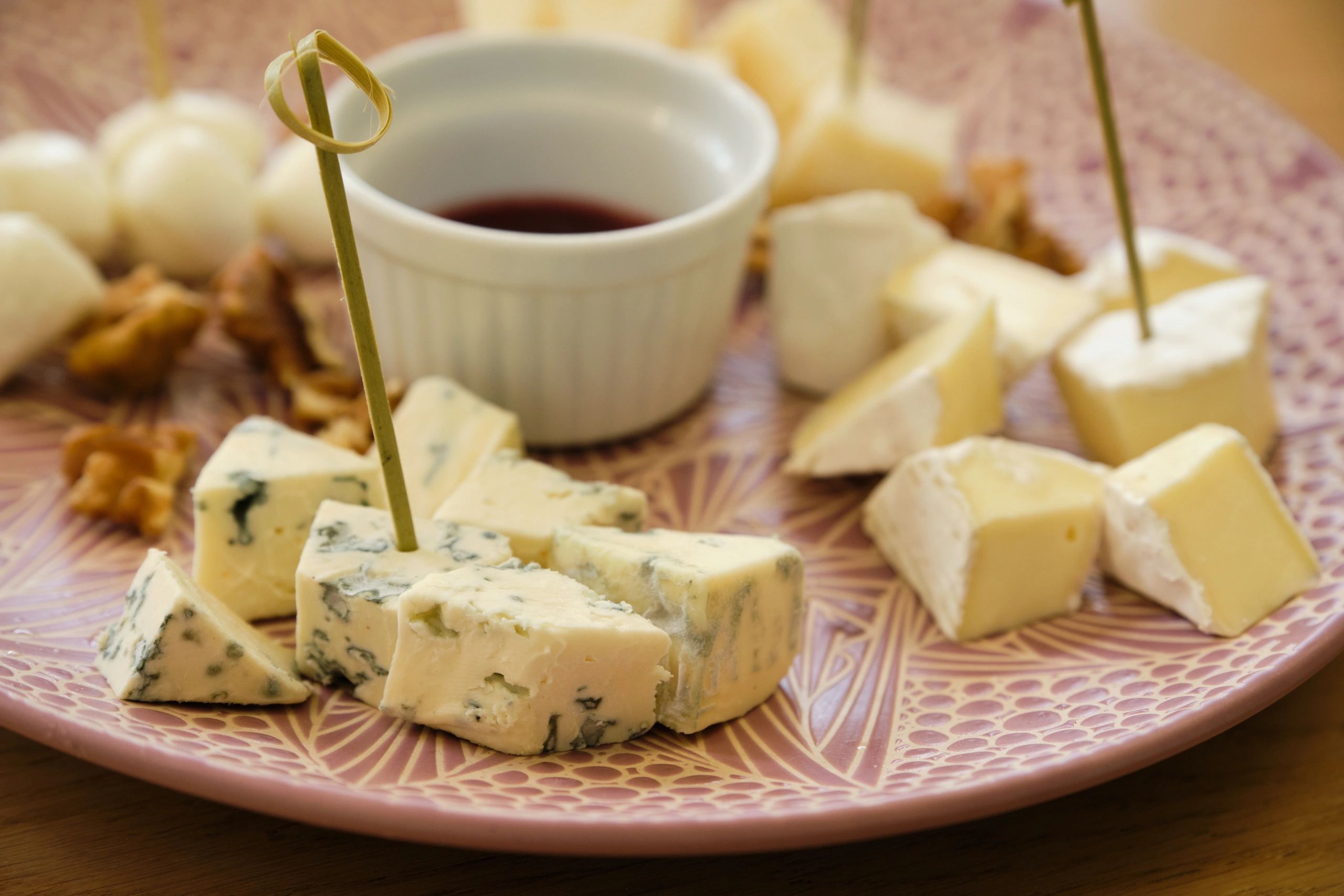 Close-up cheese platter with assorted cheeses and walnuts